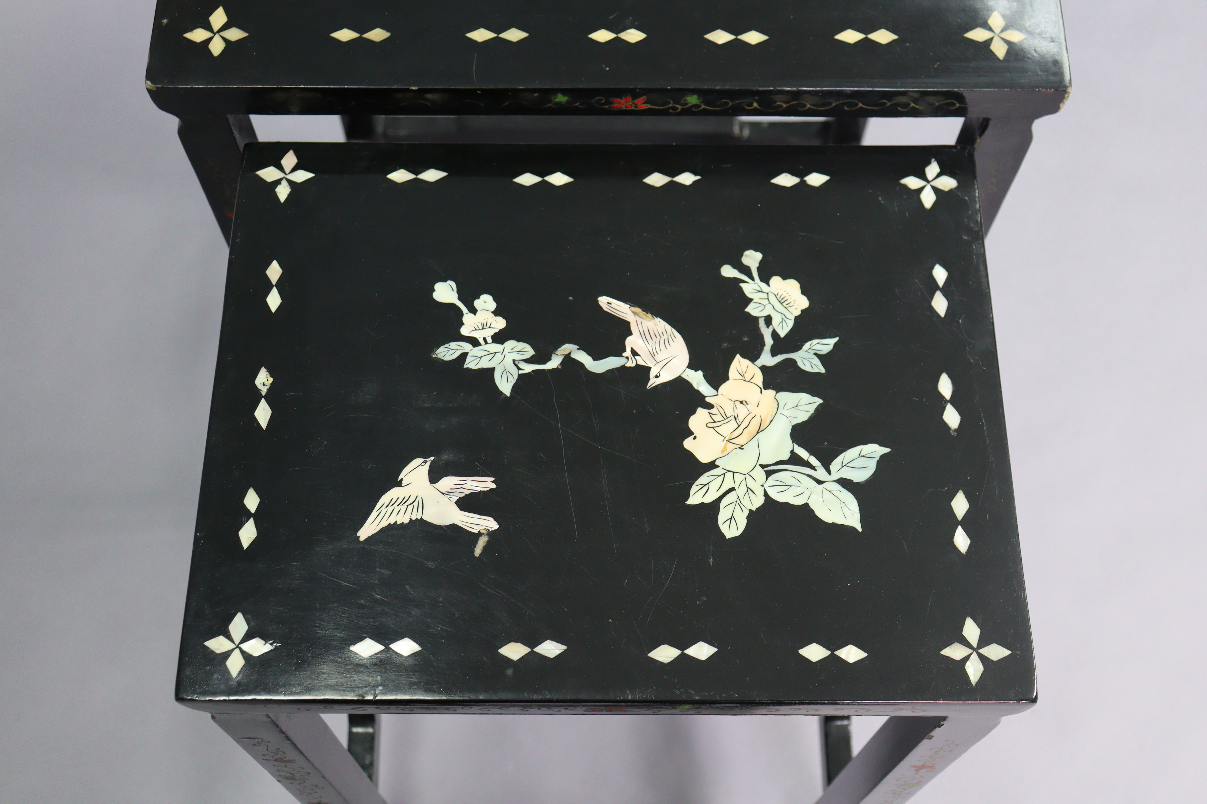 A nest of four Chinese lacquered occasional tables, each with inlaid mother-of-pearl & painted - Image 3 of 6