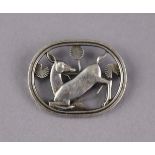 A Georg Jensen sterling pierced oval ‘Kneeling Fawn’ brooch designed by Arno Malinowski, 1¾” wide,