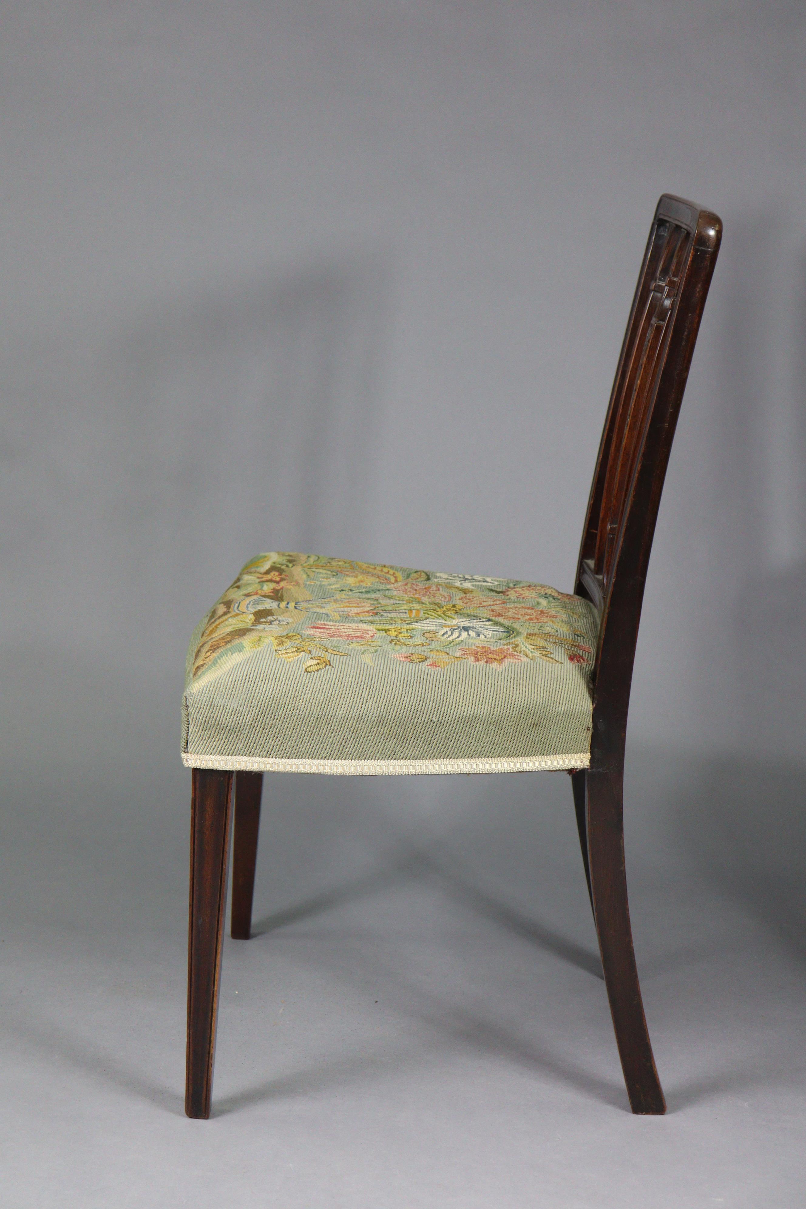 A set of four 19th century dining chairs with carved foliate decoration to the rail-backs, padded - Image 6 of 6