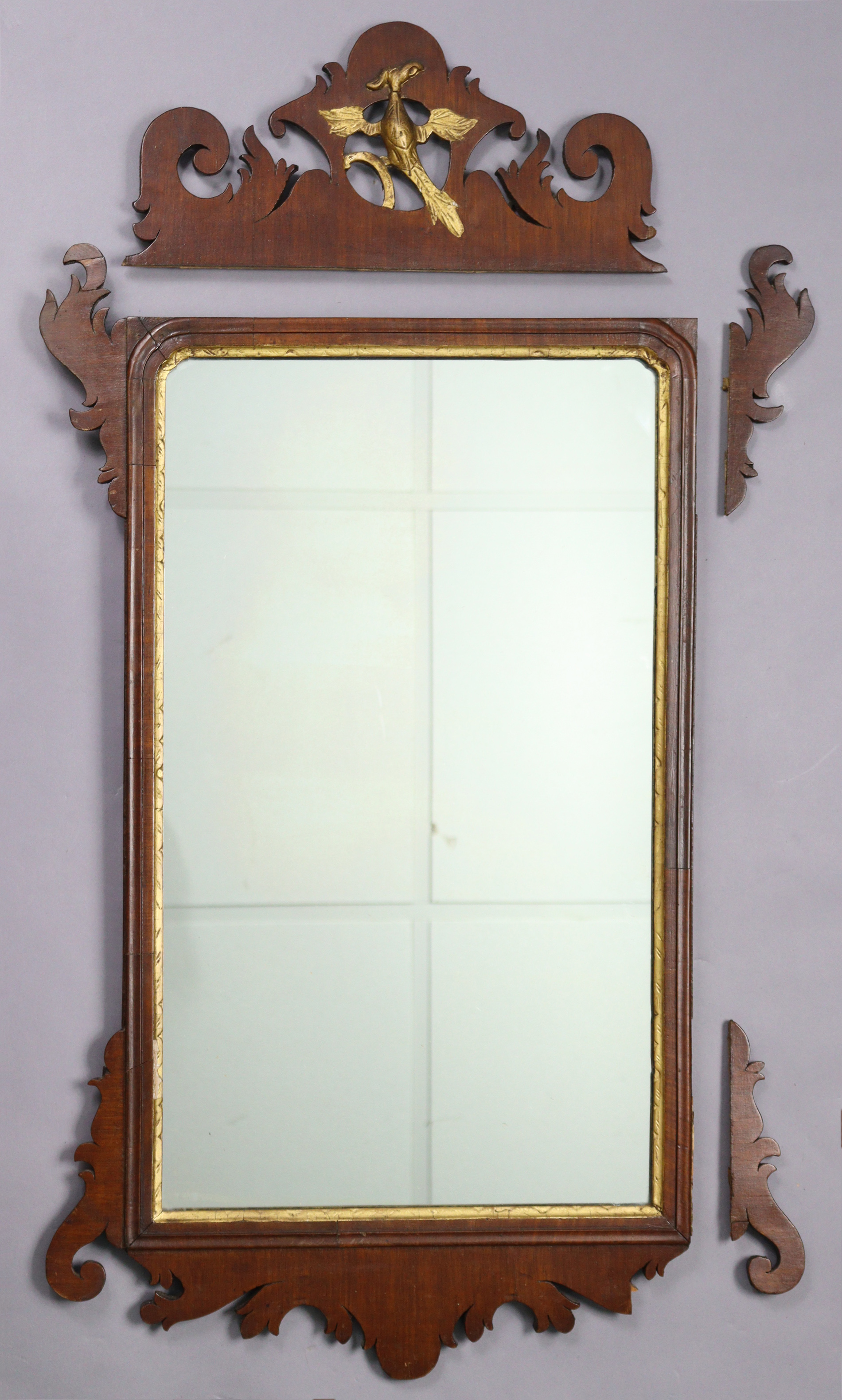 A George III mahogany rectangular wall mirror in fret-carved frame with gilt Ho-ho bird & inner