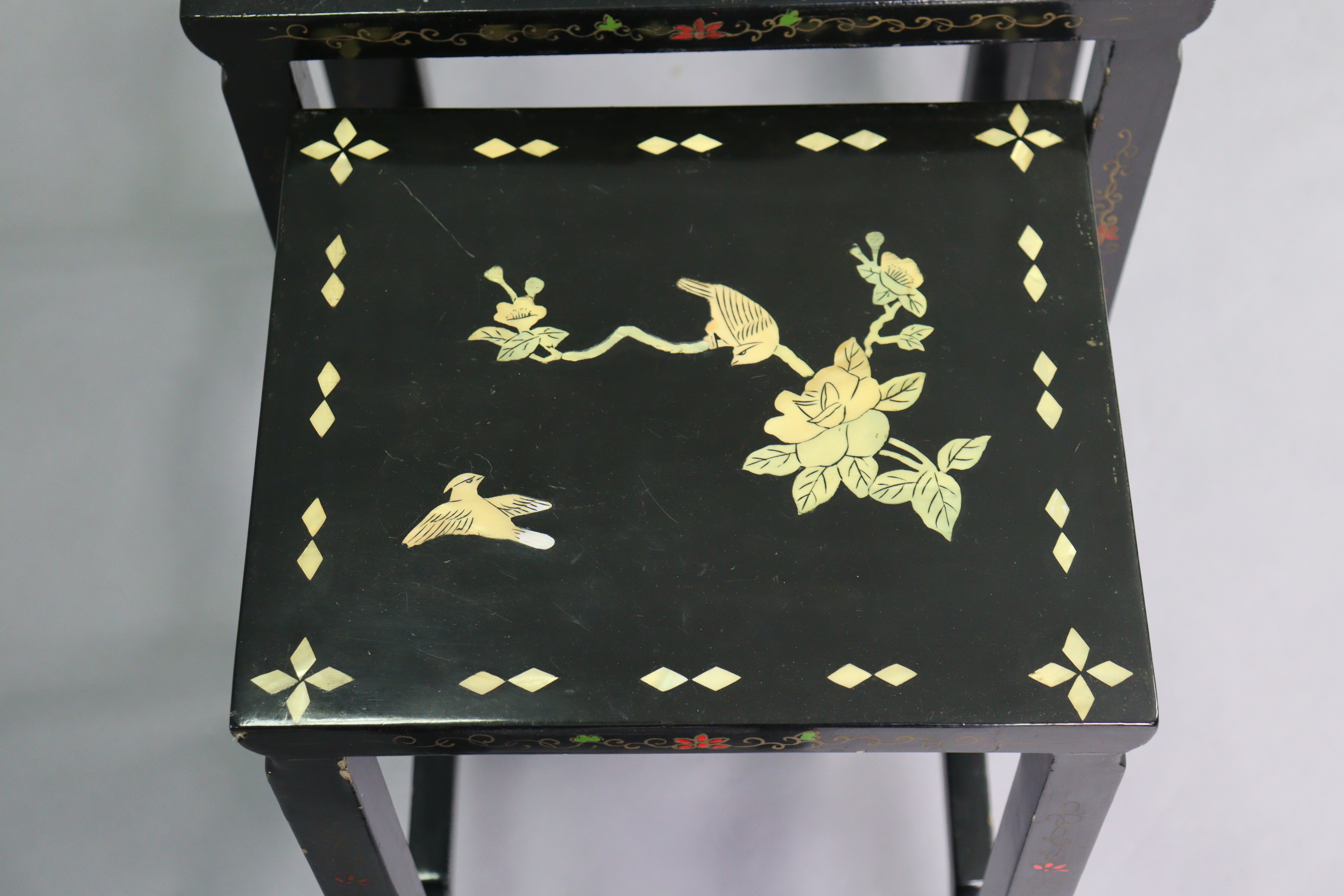 A nest of four Chinese lacquered occasional tables, each with inlaid mother-of-pearl & painted - Image 4 of 6