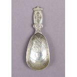 A Liberty & Co. silver caddy spoon designed by Bernard Cuzner, the flat handle & elongated oval bowl
