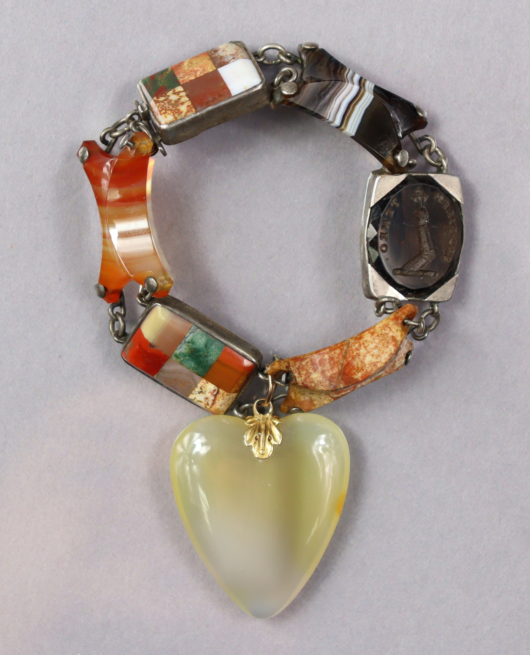 A Scottish flexible hardstone bracelet comprising various coloured stones, an intaglio seal, & with