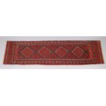 A Meshwari runner of madder ground with repeating geometric design in narrow borders, 23” wide x 97”