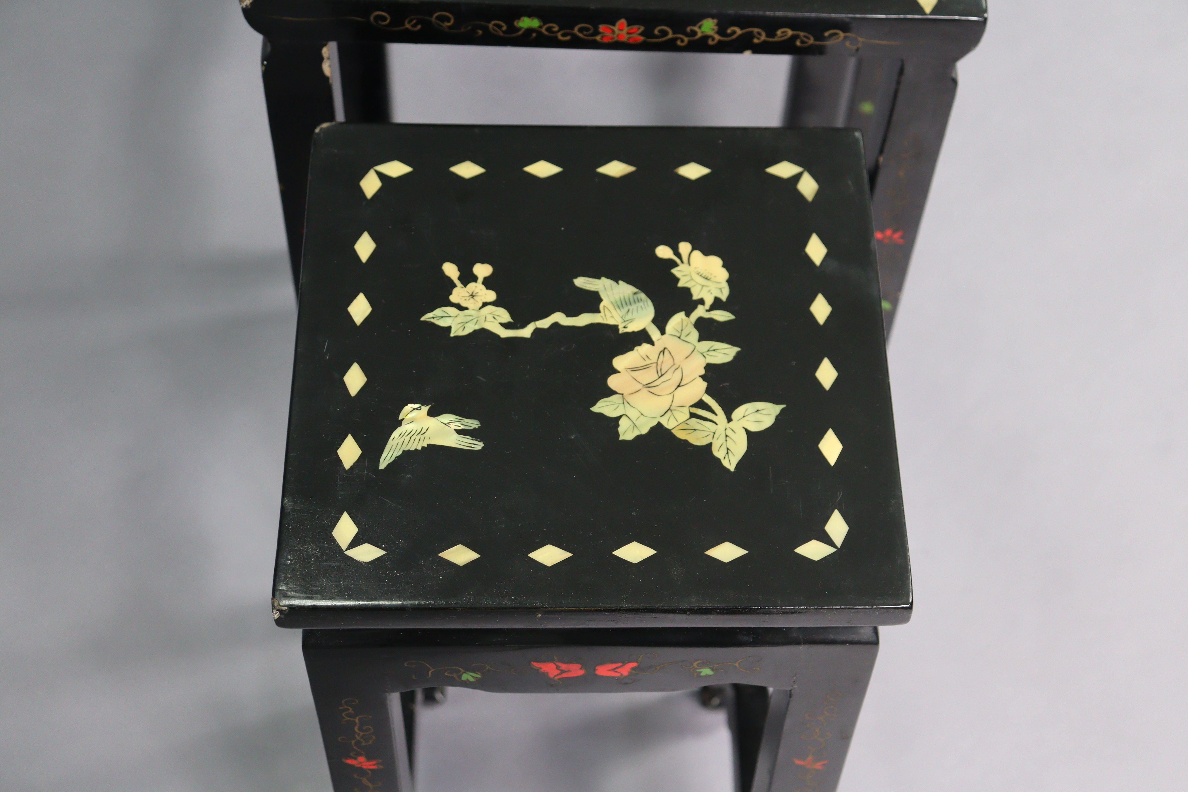 A nest of four Chinese lacquered occasional tables, each with inlaid mother-of-pearl & painted - Image 5 of 6