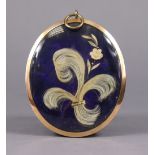 A 19th century pinchbeck large portrait miniature frame inset hair locket to reverse on a blue