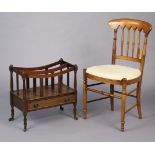 A mahogany two-division canterbury fitted with a long drawer, & on turned legs with steel castors,