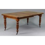 A late 19th century oak extending dining table with canted corners & moulded edge to the rectangular