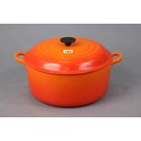 A Le Creuset volcanic enamelled cast-iron circular two-handled casserole pot, 12¼” diameter.