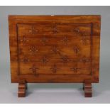 A teak firescreen with all-over carved floral decoration, & on shaped feet, 36¼” wide x 31¾” high.