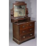 An Edwardian walnut dressing chest with a rectangular swing mirror to the stage back, fitted three
