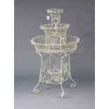 A Victorian-style white painted wirework four-tier planter, 25” diameter x 42” high.