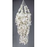 A contemporary large pendant light fitting, composed of white-painted jacaranda seeds and hung