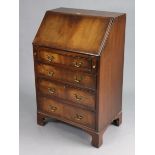 A small mahogany bureau with a fitted interior enclosed by a fall-front above four long graduated