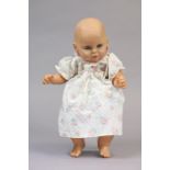 A large celluloid baby doll (Z 65-20), 23” tall, dressed.