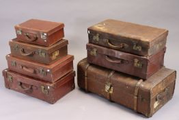 A vintage fibre-covered travelling trunk with a hinged lift-lid, 33” wide; & six various vintage