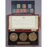 A set of three bronze medals commemorating the tree different British kings who reigned in the