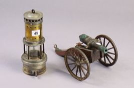 A brass & steel minor’s lamp, 9¾” high; & a model canon, 10” long