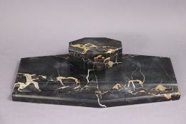 An Art Deco black marble desk inkstand of canted rectangular form, the hinged lid enclosing two