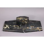 An Art Deco black marble desk inkstand of canted rectangular form, the hinged lid enclosing two