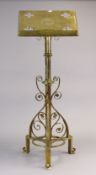 An Edwardian brass lectern with a pierced & engraved rectangular top, & on a cylindrical centre