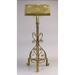 An Edwardian brass lectern with a pierced & engraved rectangular top, & on a cylindrical centre