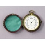 A vintage Negretti & Zambra of London brass-cased pocket barometer (No. 10183), with a crimson
