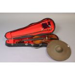 A violin & bow (violin 26” long, w.a.f), with case; & a drummer’s thin crash cymbal (split to