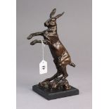 A limited edition bronzed metal sculpture of a hare stood on its hind legs, signed J.P (no 1/8), & m