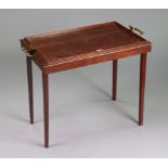 An early 20th century “Osterley” mahogany table tray with brass side handles, and on fold away legs,