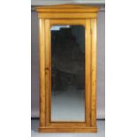 A 19th century inlaid-pine wardrobe with a moulded cornice, having a fitted interior enclosed by a