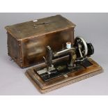 A vintage hand sewing machine bears plaque “T. Rhodes and Sons of Silver St Halifax”, with case.