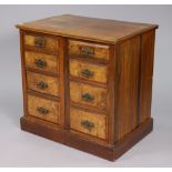 A walnut small chest fitted two ranks of four long graduated drawers with brass swing handles, &