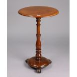 A 19th century mahogany occasional table with a circular top, & on a vase-turned centre column &