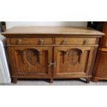 An early 20th century oak sideboard fitted two frieze drawers above cupboard enclosed by a pair o