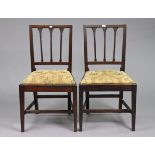 A pair of 19th century mahogany rail-back dining chairs each with a padded drop-in-seat, & on square