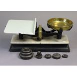 A set of vintage shop’s counter-top scales mounted on an ebonised wooden plinth inset with white