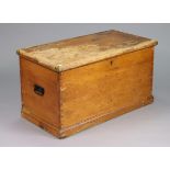 A Victorian pine blanket box with a hinged lift-lid, with wrought-iron side handles, & on a plinth