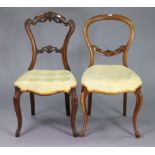 A Victorian carved beech balloon-back occasional chair with a padded seat, & on slender cabriole