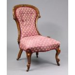 A mid-Victorian mahogany spoon-back easy chair with carved foliate decoration, later upholstered