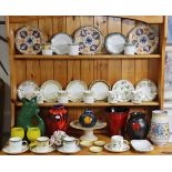 Four Poole Pottery vases of various shapes and designs, twelve Wedgwood bone china coffee cans and