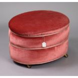 A mid-20th century oval stool upholstered pink velour, & on ceramic castors, 23” wide x 15¾” high.