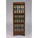 A small oak three-tier standing open bookcase, 12” wide x 35” high; & fifteen volumes by Charles