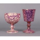 Two early 19th century pink lustre pottery goblets, each with all-over splash decoration, on knop