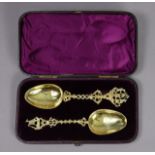 Two continental silver-gilt presentation spoons, each with different cast & pierced stem with