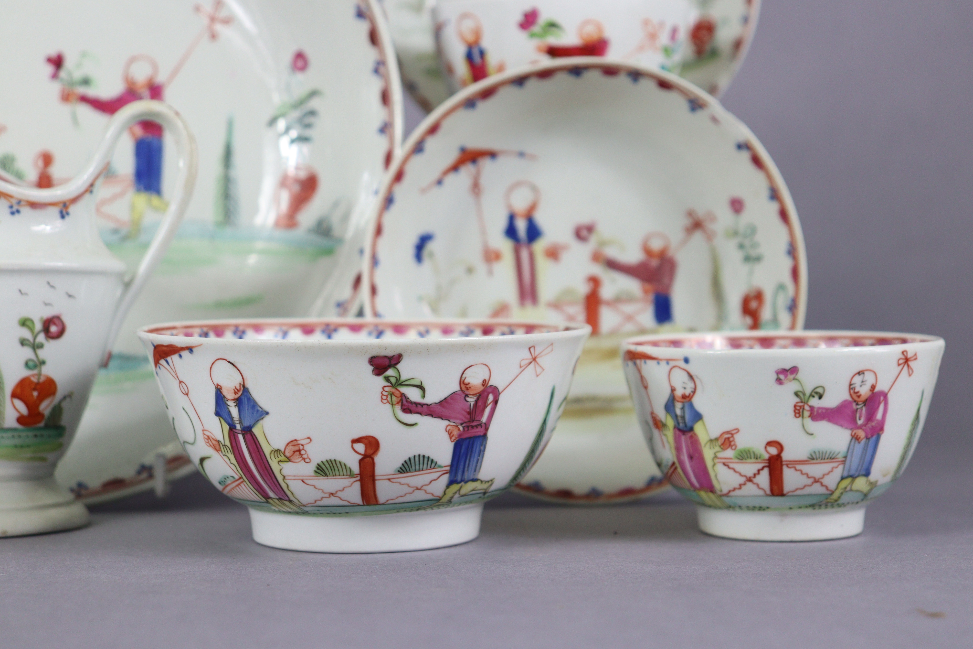 An 18th century Newhall porcelain part tea service, decorated in coloured enamels with chinoiserie - Image 4 of 17
