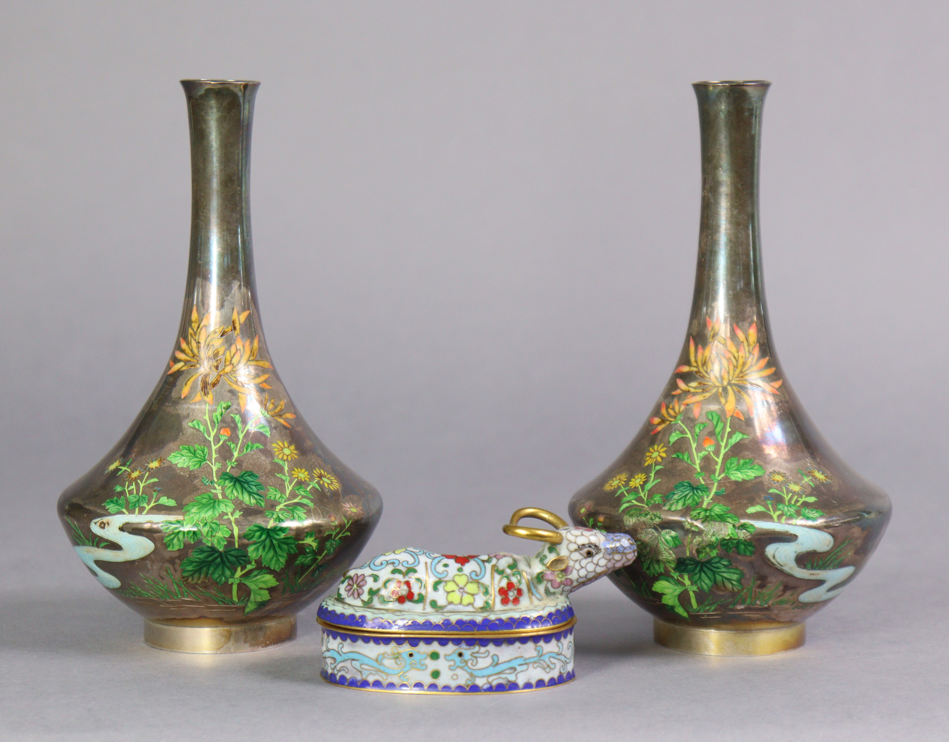 A pair of early 20th century Japanese white metal & enamelled vases, each decorated with flowers