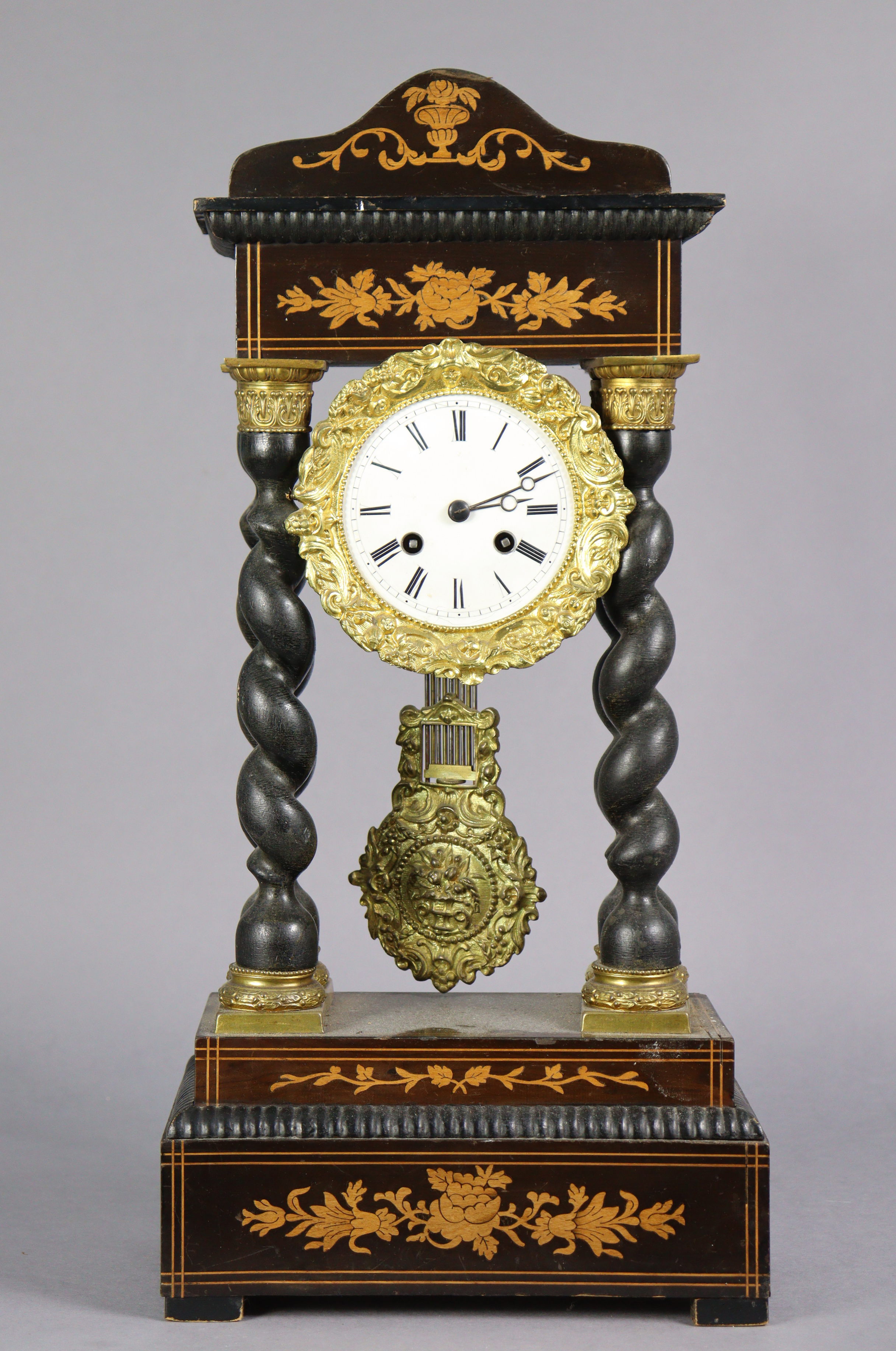 A late 19th century inlaid-mahogany portico clock, with foliate gilt brass mounts & pendulum, on