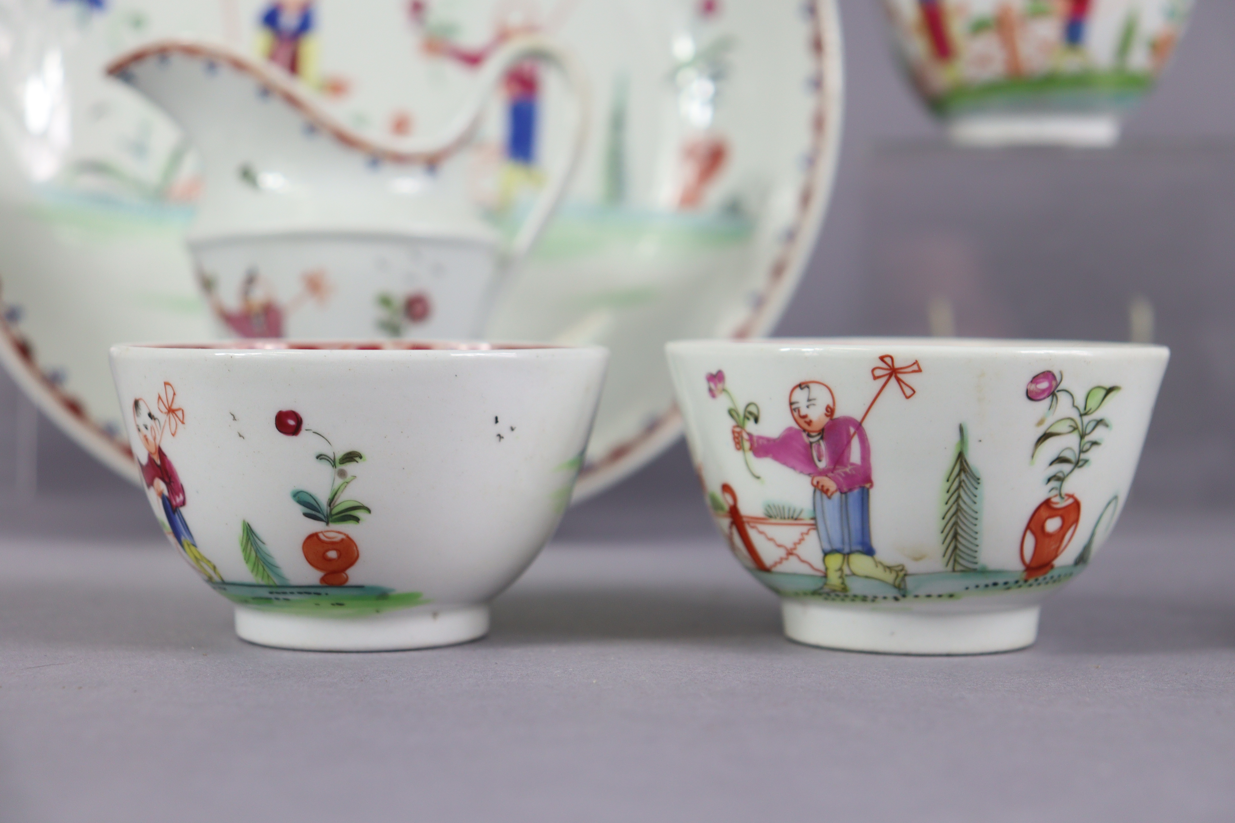 An 18th century Newhall porcelain part tea service, decorated in coloured enamels with chinoiserie - Image 11 of 17