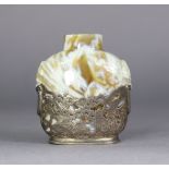 A Chinese agate snuff bottle, of caramel tone with white striations, carved lion-mask side handles &